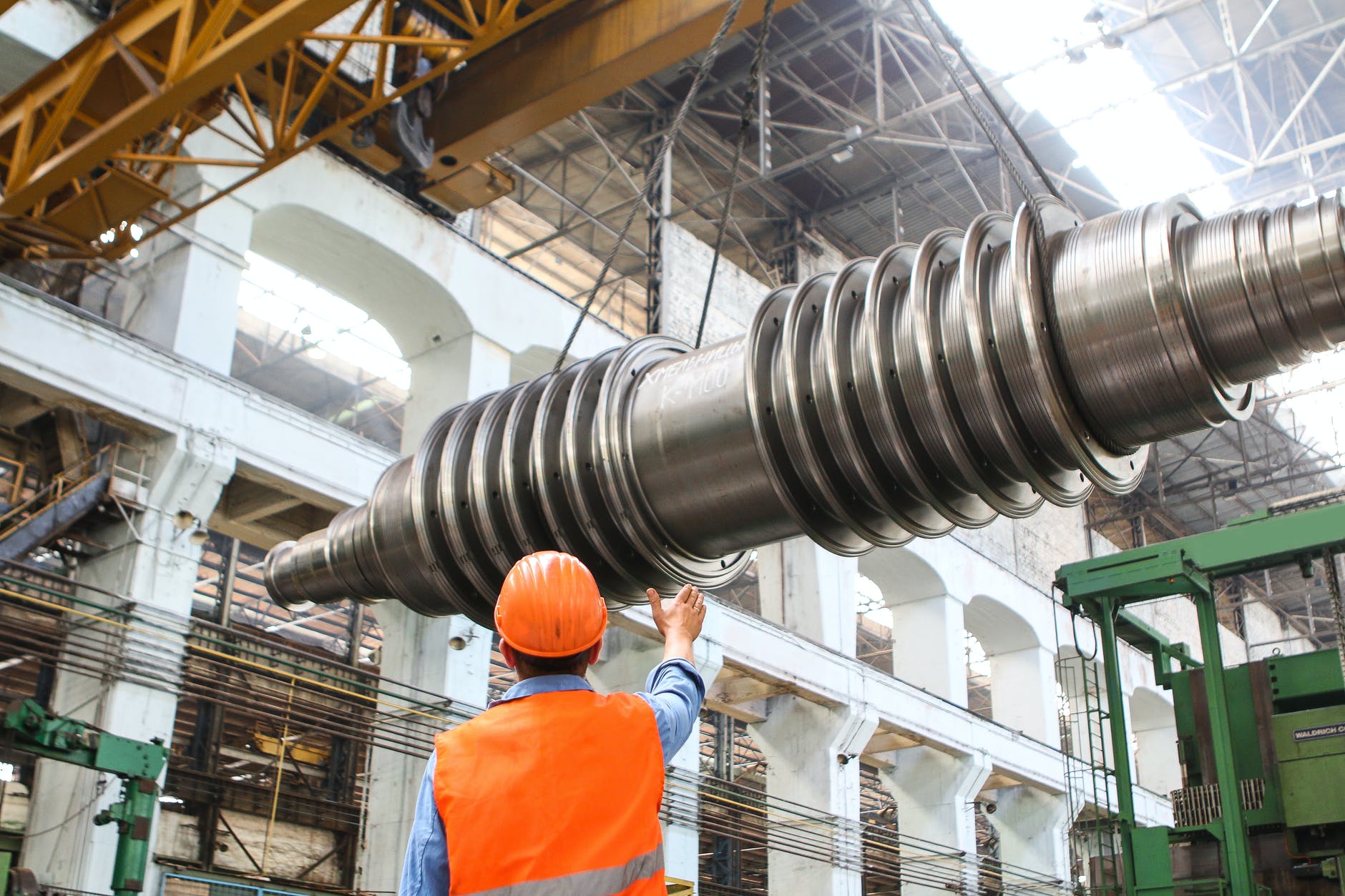 man standing beside heavy equipment