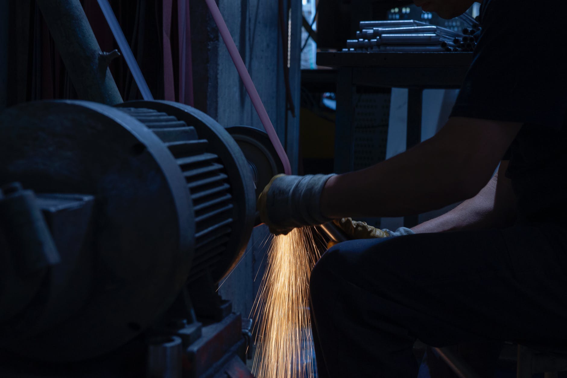 man grinding a metal