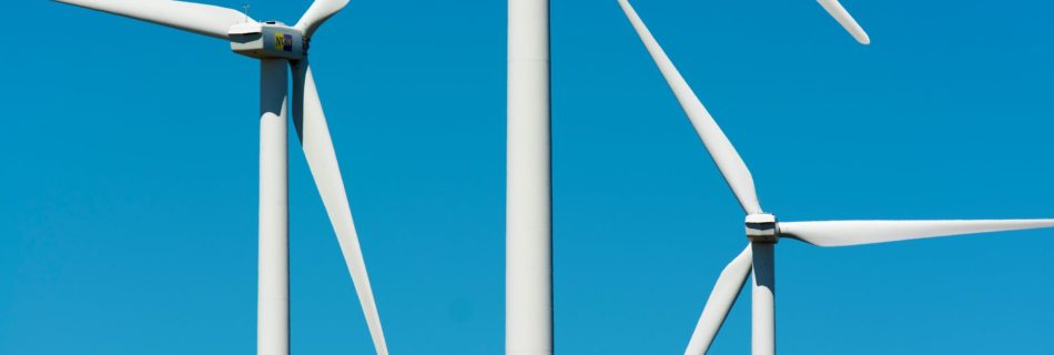 white wind turbine under blue sky